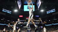 San Antonio Spurs center Luke Kornet (7) dunks over Utah Jazz center Kyle Filipowski (22) and forward Taylor Hendricks (0) during the second half at Frost Bank Center