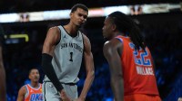 San Antonio Spurs forward Victor Wembanyama (1) flexes in front of Oklahoma City Thunder guard Cason Wallace (22) during the third quarter at T-Mobile Arena.