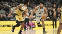 San Antonio Spurs guard Dylan Harper (2) drives to the basket against Washington Wizards forward Marvin Bagley III (35) during the first half at Frost Bank Center.