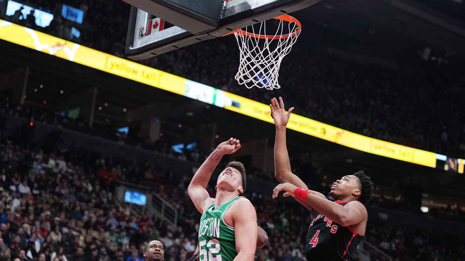 Boston Celtics center Luka Garza (52) drives to the basket as Toronto Raptors forward Scottie Barnes (4) tries to defend during the first quarter at Scotiabank Arena.