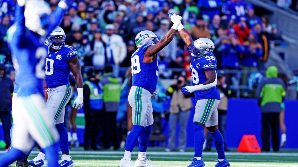 Seattle Seahawks defensive end Leonard Williams (99) and Seattle Seahawks linebacker Derick Hall (58) celebrate after a play