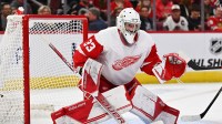 Detroit Red Wings goaltender Sebastian Cossa (33) defends the net against the Chicago Blackhawks at United Center.