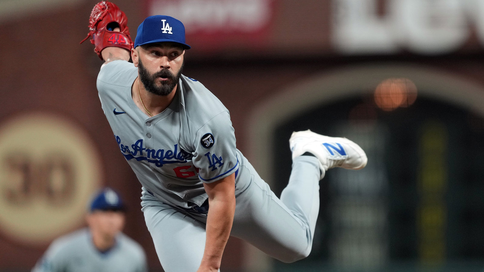 Los Angeles Dodgers pitcher Tanner Scott (66) throws a pitch against the San Francisco Giants during the tenth inning at Oracle Park. Mandatory Credit: Darren Yamashita-Imagn Images