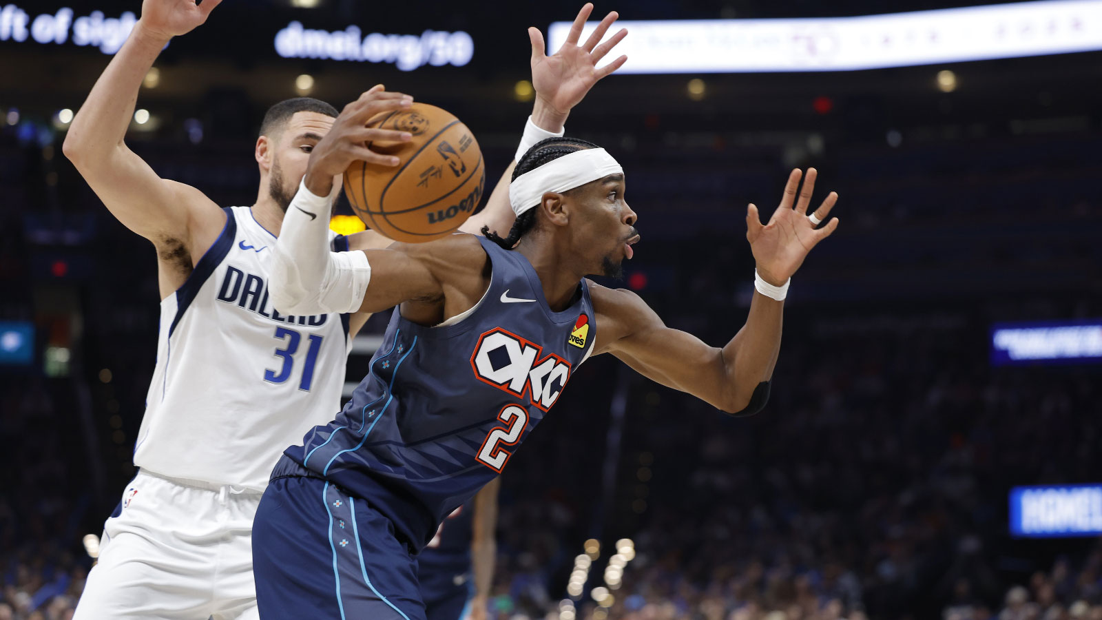 Oklahoma City Thunder guard Shai Gilgeous-Alexander (2) moves the ball past Dallas Mavericks guard Klay Thompson (31) during the second half at Paycom Center.