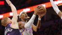 Oklahoma City Thunder guard Shai Gilgeous-Alexander (2) goes to the basket past Minnesota Timberwolves guard Donte DiVincenzo (0) in the first quarter at Target Center. Mandatory Credit: Bruce Kluckhohn-Imagn Images