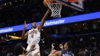 Cleveland Cavaliers center Evan Mobley (4) shoots the ball over Washington Wizards guard CJ McCollum (3) and Wizards forward Marvin Bagley III (35) in the second half at Capital One Arena.