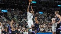 San Antonio Spurs guard Stephon Castle (5) shoots over Sacramento Kings guard Russell Westbrook (18) in the second half at Frost Bank Center.