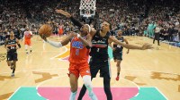 Thunder guard Shai Gilgeous-Alexander (2) drives to the basket past San Antonio Spurs forward Victor Wembanyama (1) during the first half at Frost Bank Center