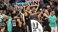 San Antonio Spurs forward Victor Wembanyama (1) leads fans on a cheer after a victory over the Oklahoma City Thunder at Frost Bank Center.