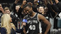 Spurs forward Harrison Barnes (40) is surrounded by teammates