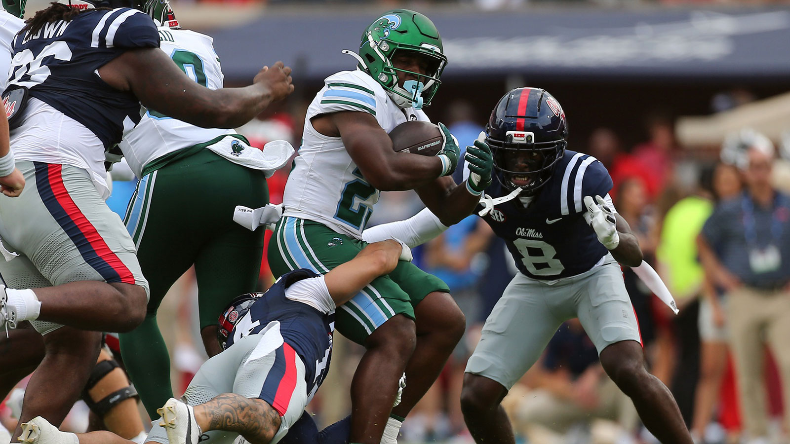 Tulane Green Wave running back Javin Gordon (23) runs the ball as Mississippi Rebels defensive backs Kapena Gushiken (14) and Antonio Kite (8) make the tackle during the second quarter at Vaught-Hemingway Stadium.