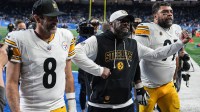 Pittsburgh Steelers coach Mike Tomlin celebrates as he walks off the field with quarterback Aaron Rodgers and defensive tackle Cameron Heyward after a 29-24 win over the Detroit Lions at Ford Field in Detroit on Sunday, Dec. 21, 2025.