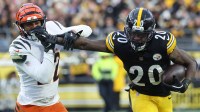 Pittsburgh Steelers running back Kaleb Johnson (20) stiff arms Cincinnati Bengals safety Geno Stone (22) during the second half at Acrisure Stadium.