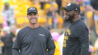Baltimore Ravens head coach John Harbaugh (left) talks with Pittsburgh Steelers head coach Mike Tomlin before a game at Heinz Field.