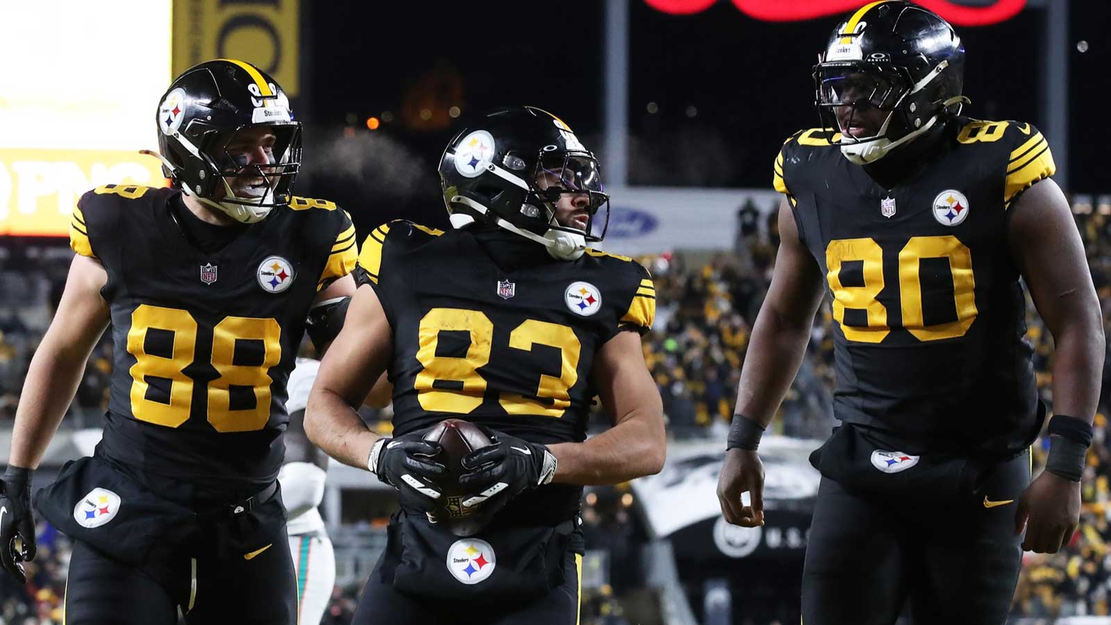Pittsburgh Steelers tight end/fullback Connor Heyward (83) celebrates with tight end Pat Freiermuth (88) and tight end Darnell Washington (80) after scoring a touchdown in the second quarter at Acrisure Stadium.