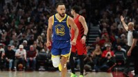 Golden State Warriors guard Stephen Curry (30) reacts after making a three-point basket against the Portland Trail Blazers during the second half at Moda Center.