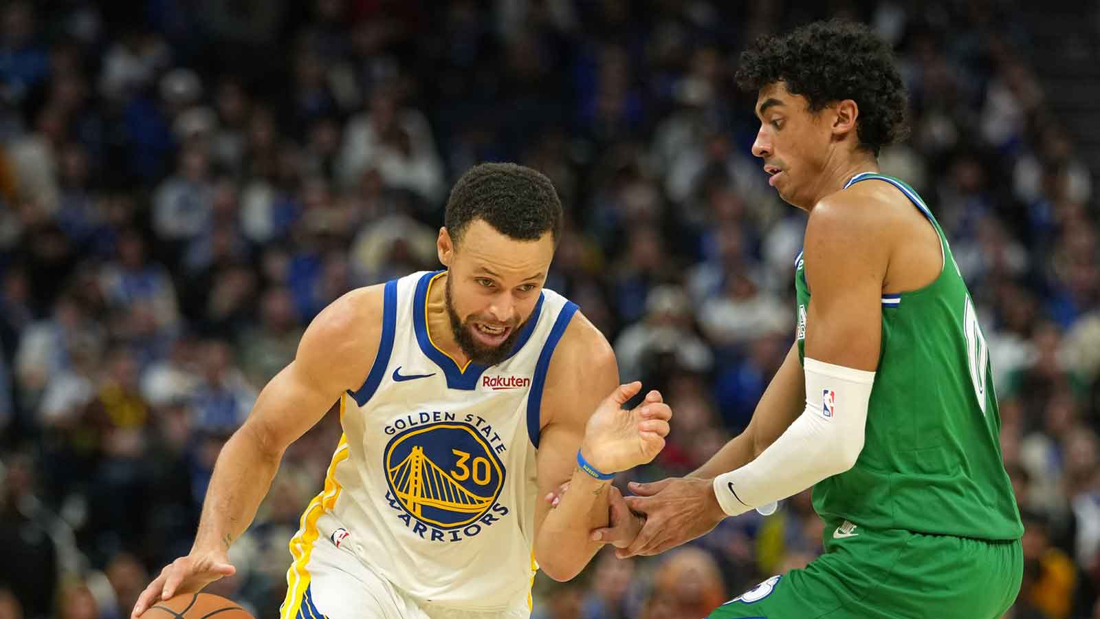 Golden State Warriors guard Stephen Curry (30) dribbles against Dallas Mavericks guard Max Christie (00) during the fourth quarter at Chase Center.