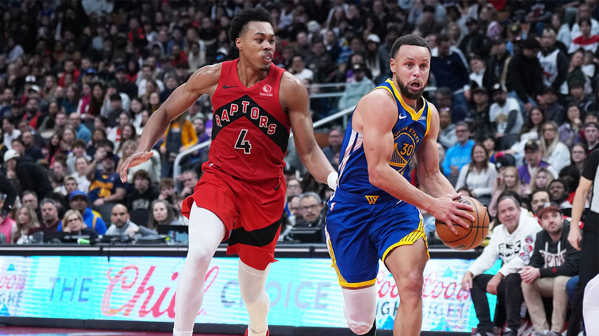 Golden State Warriors guard Stephen Curry (30) controls the ball as Toronto Raptors forward Scottie Barnes (4) tries to defend during the overtime at Scotiabank Arena.