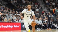 San Antonio Spurs guard Stephon Castle (5) dribbles in the first half against the Sacramento Kings at Frost Bank Center.