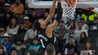 San Antonio Spurs forward Victor Wembanyama (1) dunks in front of Cleveland Cavaliers forward Dean Wade (32) in the first half at Frost Bank Center.