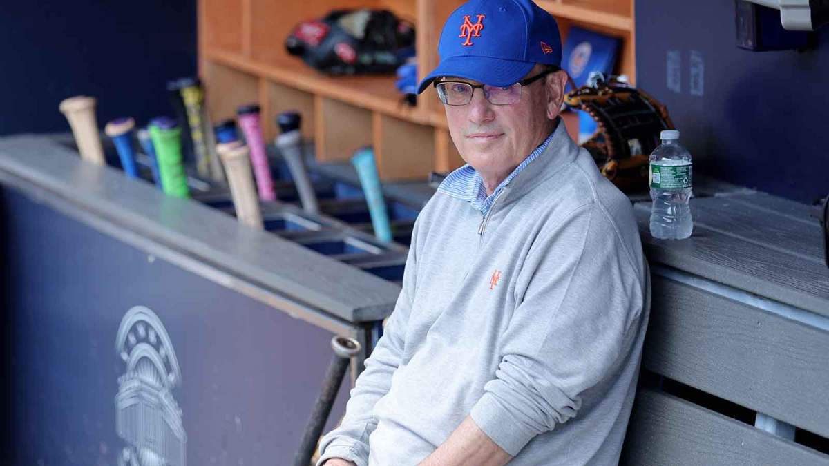 New York Mets owner Steve Cohen sits in the dugout after batting practice before a game against the New York Yankees at Yankee Stadium.
