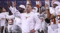 Texas Longhorns head coach Steve Sarkisian and team gesture after the game against the Georgia Bulldogs at Sanford Stadium.