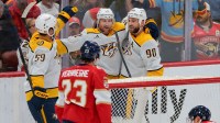 Nashville Predators center Steven Stamkos (91) celebrates with defenseman Roman Josi (59) and center Ryan O'Reilly (90) after scoring against the Florida Panthers during overtime at Amerant Bank Arena.