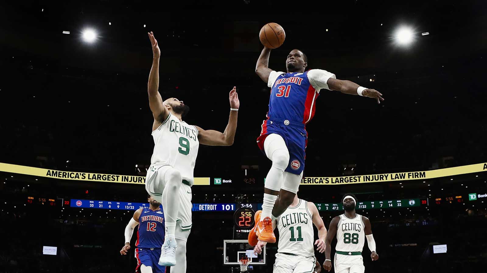 Detroit Pistons guard Javonte Green (31) goes in for a dunk past Boston Celtics guard Derrick White (9) during the second half at TD Garden.