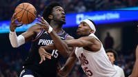 Phoenix Suns center Mark Williams (15) goes to the basket while being fouled by Cleveland Cavaliers forward Nae'Qwan Tomlin (35) during the first half at Rocket Arena.