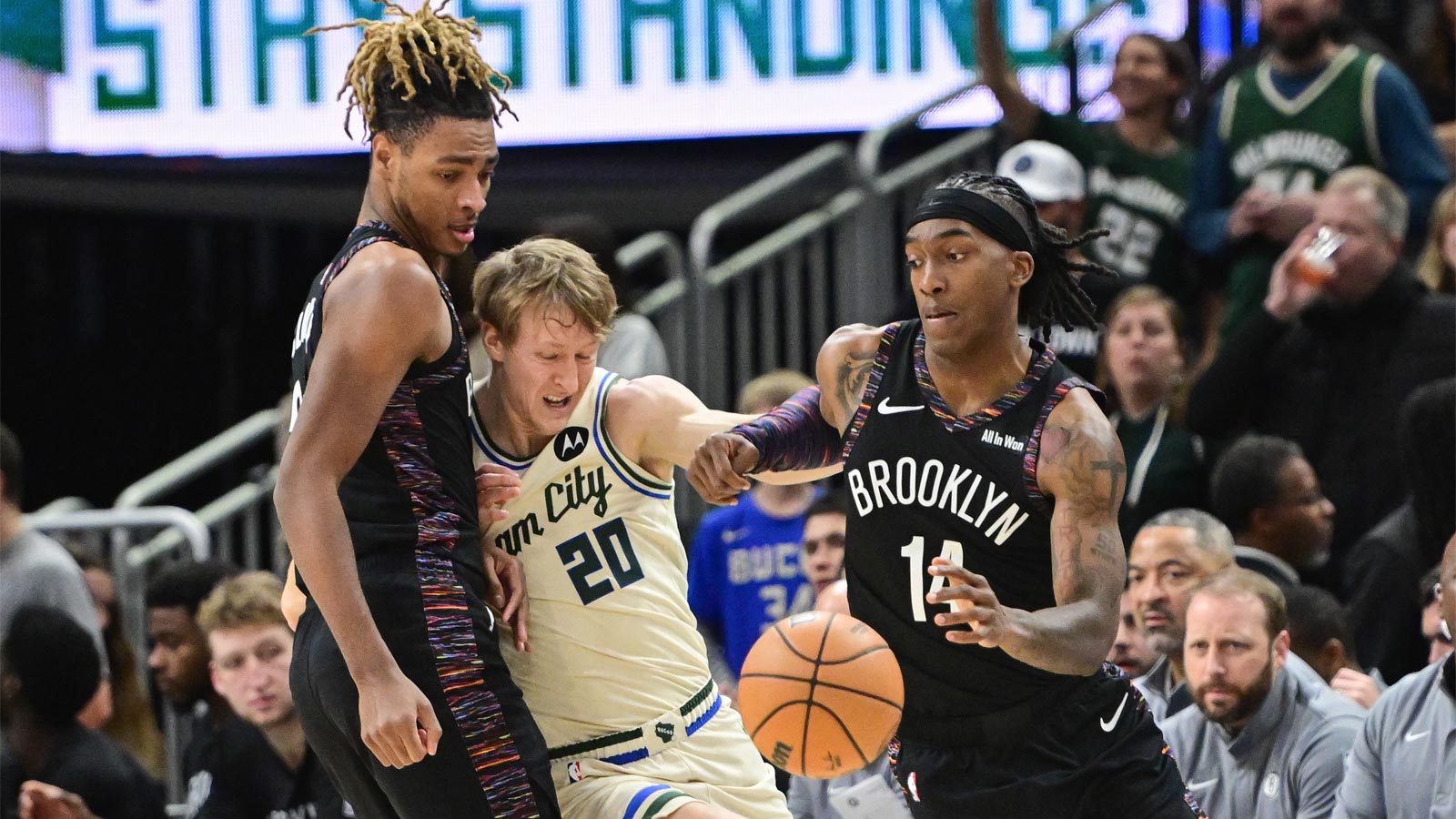 Brooklyn Nets guard Terance Mann (14) drives for the basket against Milwaukee Bucks guard AJ Green (20) in the first quarter as forward Noah Clowney (21) looks on at Fiserv Forum.