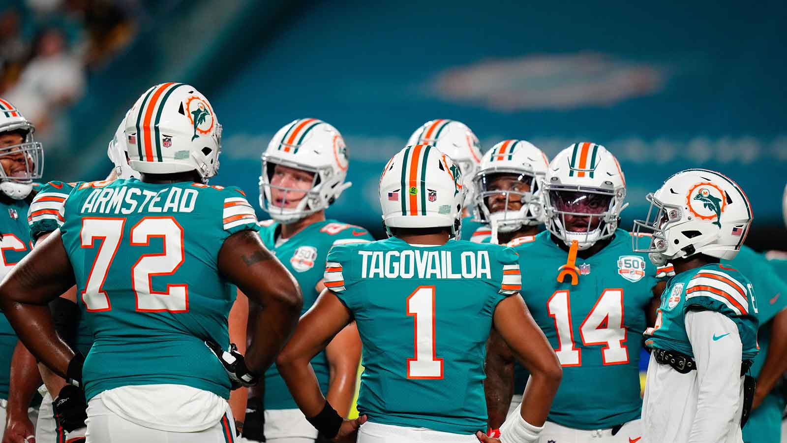 Miami Dolphins offensive tackle Terron Armstead (72) and Miami Dolphins quarterback Tua Tagovailoa (1) talk to teammates prior to a game against the Pittsburgh Steelers at Hard Rock Stadium.
