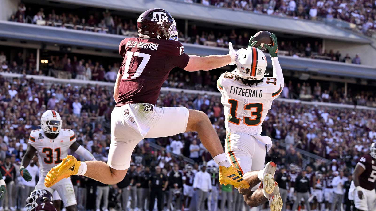 Miami Hurricanes defensive back Bryce Fitzgerald (13) intercepts a pass in front of Texas A&M Aggies tight end Theo Melin Öhrström (17) to clince the Miami win at Kyle Field. 