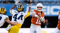 Michigan Wolverines defensive lineman Damon Payne (44) tips a pass from Texas Longhorns quarterback Arch Manning (16) during the first half at Camping World Stadium.
