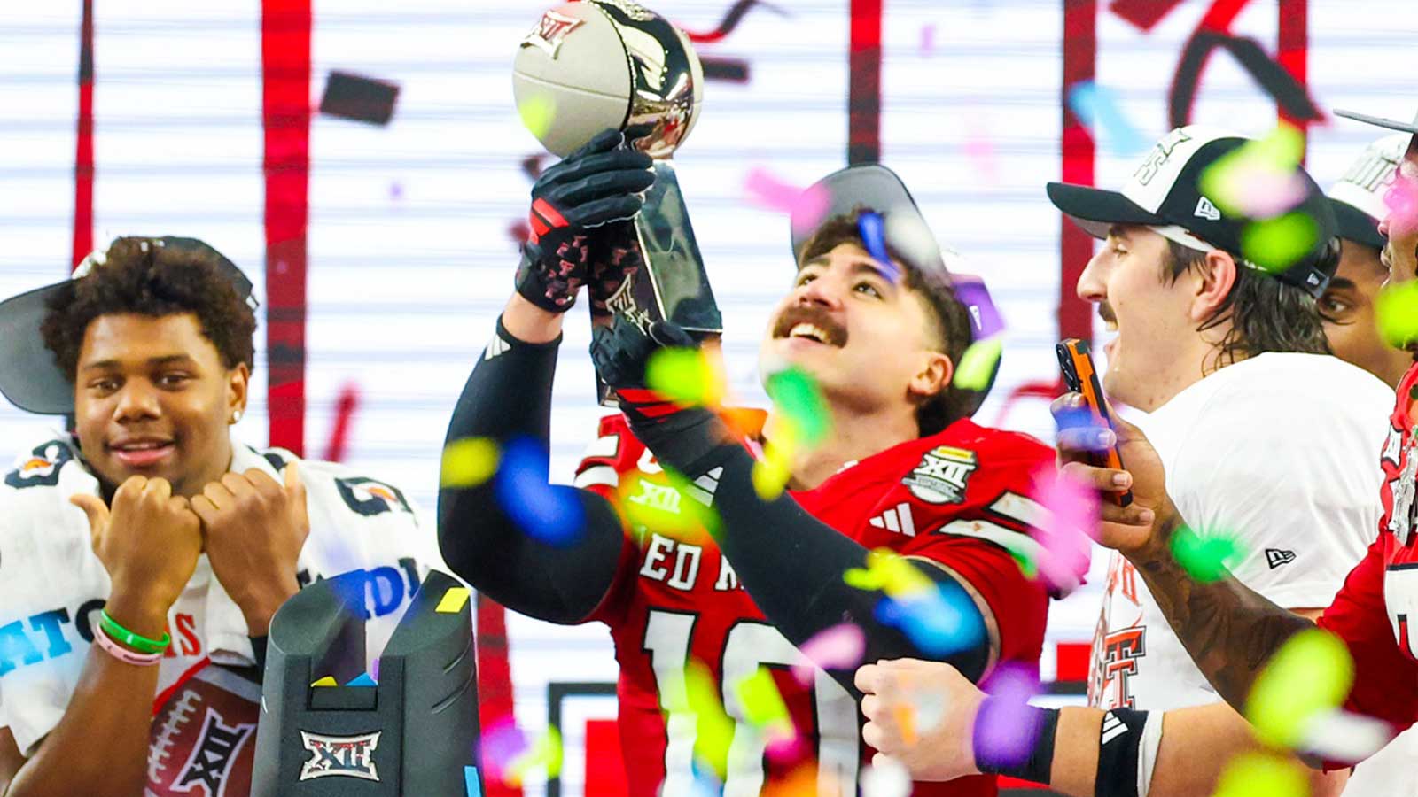 Texas Tech Red Raiders linebacker Jacob Rodriguez (10) celebrates with the Big 12 Championship trophy after the game against the BYU Cougars at AT&T Stadium.