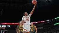 Texas Longhorns forward Madison Booker (35) scores a layup ahead of Baylor Bears forward Darianna Littlepage-Buggs (5) during the first half.