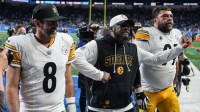 Pittsburgh Steelers coach Mike Tomlin celebrates as he walks off the field with quarterback Aaron Rodgers and defensive tackle Cameron Heyward after a 29-24 win over the Detroit Lions at Ford Field in Detroit on Sunday, Dec. 21, 2025.