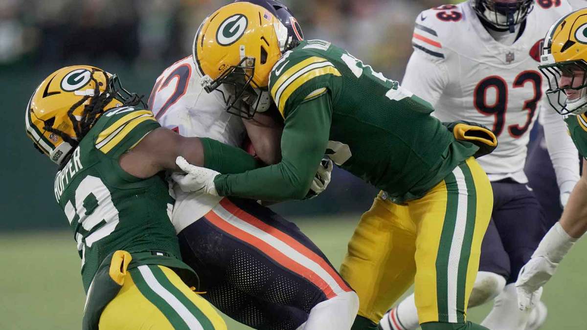 Chicago Bears wide receiver Devin Duvernay (12) is tackled by Green Bay Packers safety Evan Williams (33) and linebacker Ty'Ron Hopper (59) on a kick return during the first quarter of their game Sunday, December 7, 2025 at Lambeau Field in Green Bay, Wisconsin.