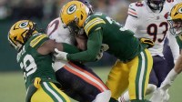 Chicago Bears wide receiver Devin Duvernay (12) is tackled by Green Bay Packers safety Evan Williams (33) and linebacker Ty'Ron Hopper (59) on a kick return during the first quarter of their game Sunday, December 7, 2025 at Lambeau Field in Green Bay, Wisconsin.