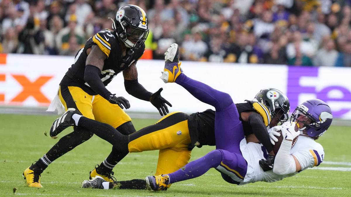 Minnesota Vikings wide receiver Adam Thielen (19) is tackled by Pittsburgh Steelers cornerback Brandin Echols (26) and linebacker Patrick Queen (6) during the second quarter during an NFL International Series game at Croke Park.