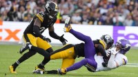 Minnesota Vikings wide receiver Adam Thielen (19) is tackled by Pittsburgh Steelers cornerback Brandin Echols (26) and linebacker Patrick Queen (6) during the second quarter during an NFL International Series game at Croke Park.