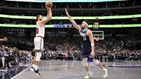 Golden State Warriors guard Stephen Curry (30) makes a three point shot over Dallas Mavericks guard Klay Thompson (31) to give the Warriors the lead during the fourth quarter at the American Airlines Center.