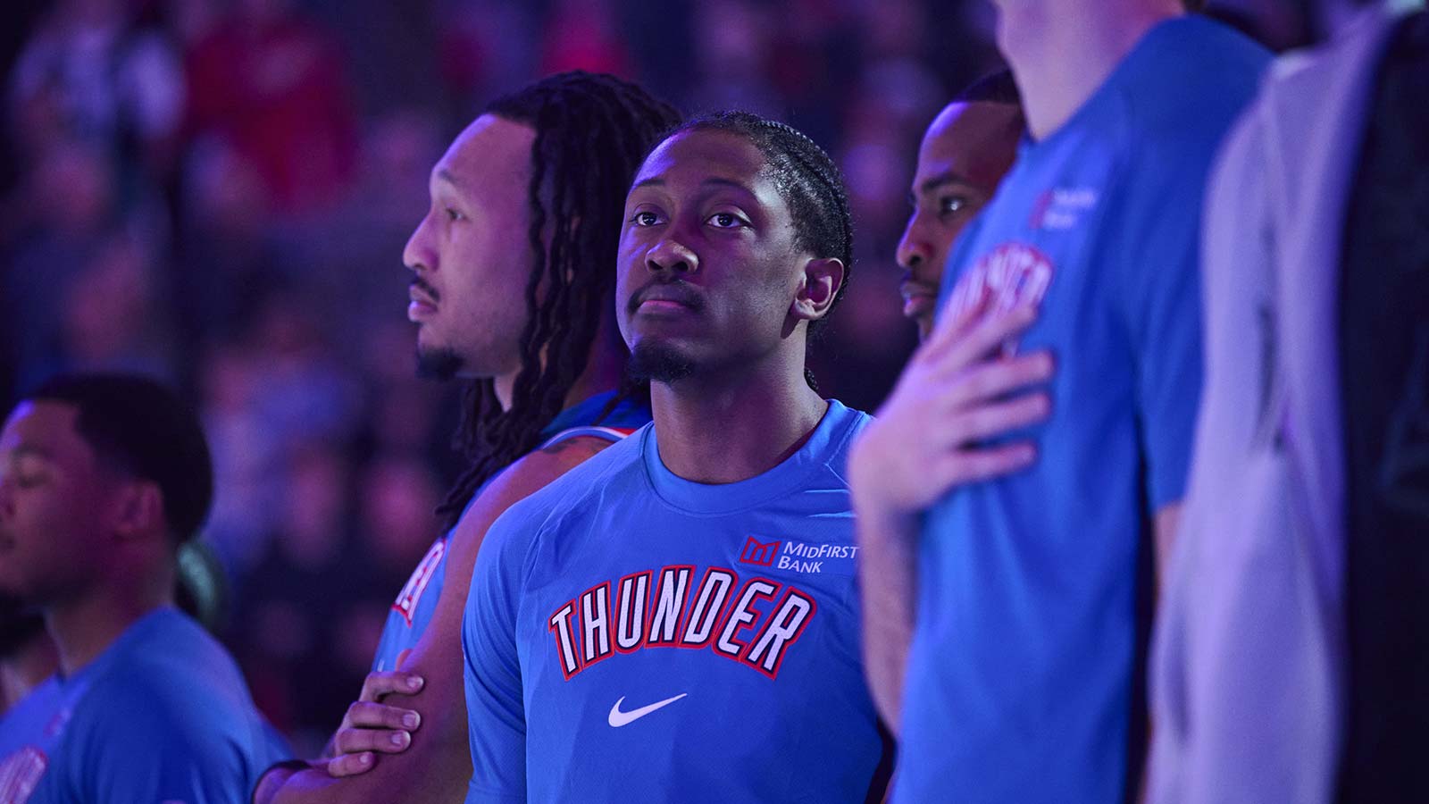Thunder guard Jalen Williams (8) stands with teammates during the singing of the national anthem before a game against the Portland Trail Blazers at Moda Center