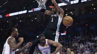 Spurs forward Victor Wembanyama (1) dunks over Oklahoma City Thunder guard Jalen Williams (8) during the second quarter at Paycom Center