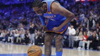 Thunder guard Jalen Williams screams at the ball as he celebrates after dunking against the Los Angeles Clippers during the second quarter at Paycom Center with the Spurs logo in the background