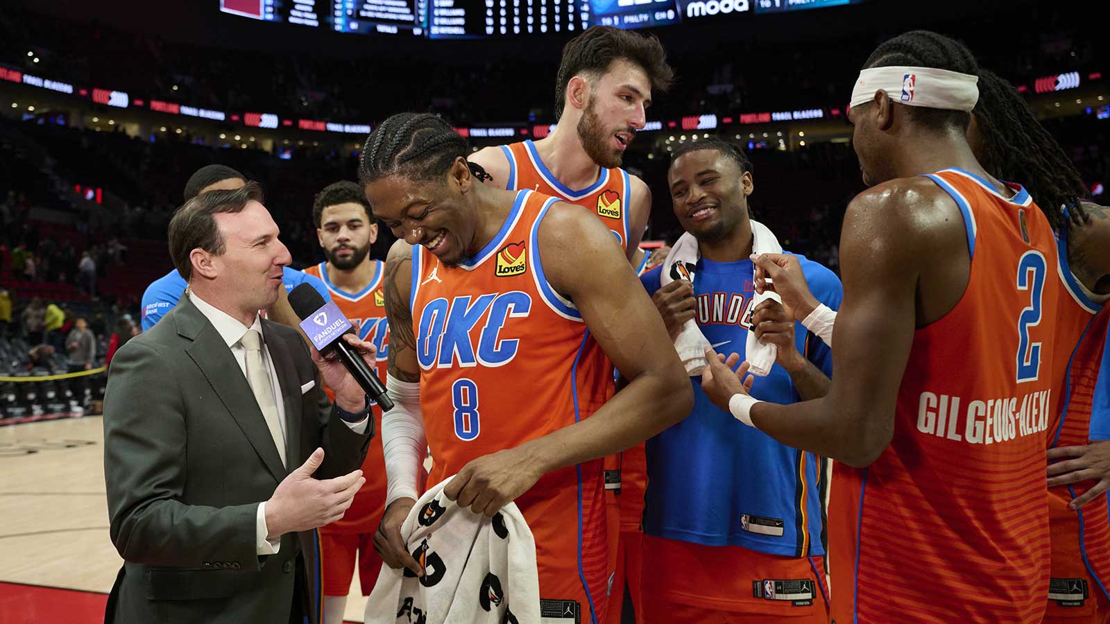 Thunder guard Jalen Williams (8) laughs during a post-game interview with teammates after a game against the Portland Trail Blazers at Moda Center