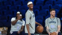 Thunder guard Luguentz Dort (5), guard Shai Gilgeous-Alexander (2) and center Isaiah Hartenstein (55) react during practice prior to the Emirates Cup semifinals at T-Mobile Arena with Thunder GM Sam Presti in the background