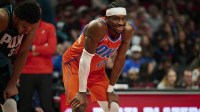 Thunder guard Shai Gilgeous-Alexander (2) smiles at a fan during the second half in a game against the Portland Trail Blazers at Moda Center with Paul Pierce and Michael Jordan in the background