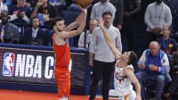 Thunder center Chet Holmgren (7) shoots a three point basket as Phoenix Suns guard Grayson Allen (8) defends the shot during the first quarter at Paycom Center