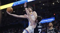 Thunder center Chet Holmgren (7) goes to the basket as San Antonio Spurs center Luke Kornet (7) defends during the second half at Paycom Center with ESPN's Kendrick Perkins in the background