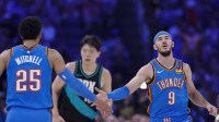 Thunder guard Alex Caruso (9) and guard Ajay Mitchell (25) celebrate after a play against the Portland Trail Blazers during the second quarter at Paycom Center with Thunder close games in the background